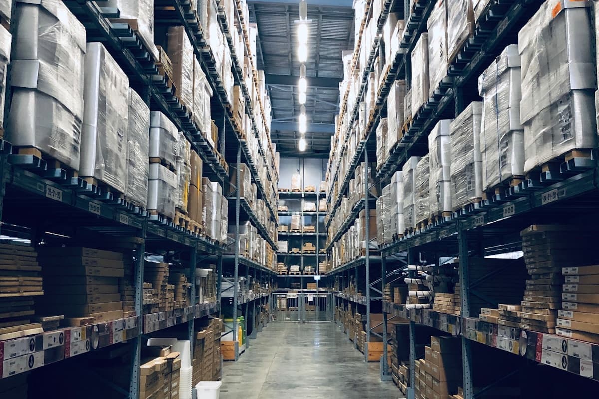 SPC flooring container loading — pallet racks with cartons staged before loading SPC flooring container loading — pallet racks with cartons staged before loading